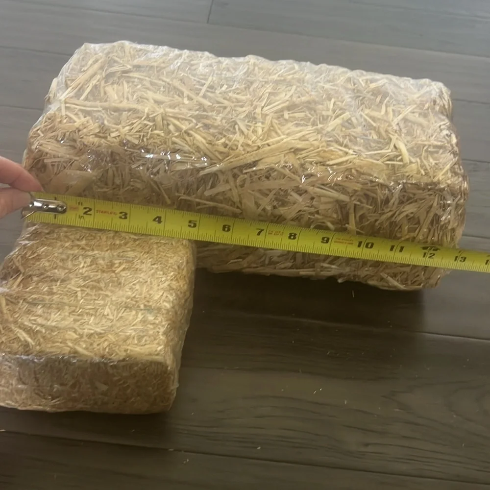 Scarecrow figurine with straw Bale
